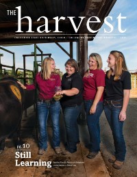 Magazine cover featuring four women inspecting rumen contents