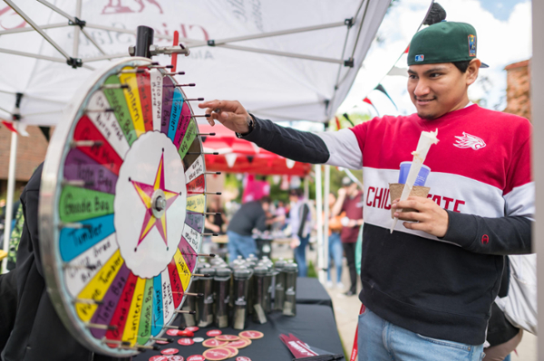 A student spins a prize wheel at Senior Send-Off