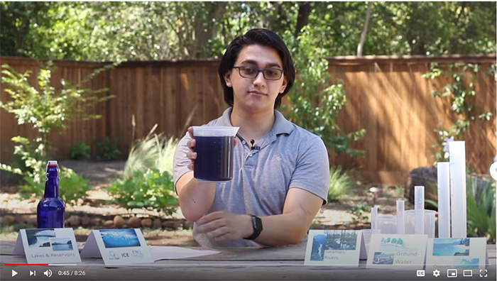 somebody performing a water experiment outdoors