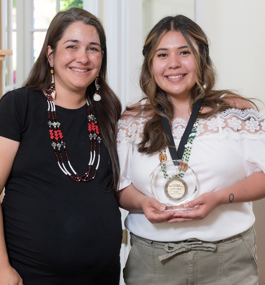 Amber Noel-Camacho (left) presents Liliana Vargas (right) with the Award for the Enhancement of Multicultural Understanding, sponsored by Student Affairs Staff during the 2022 Student Leadership Awards