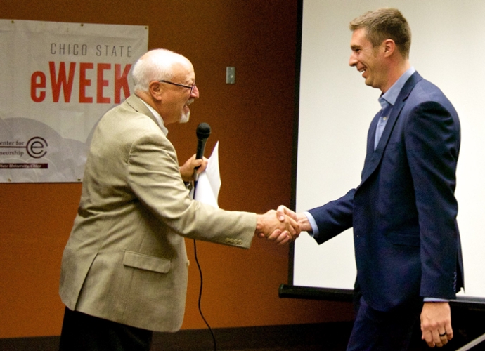 Alex Van Dewark shakes hands with Peter Straus, director of the Center for Entrepreneurship