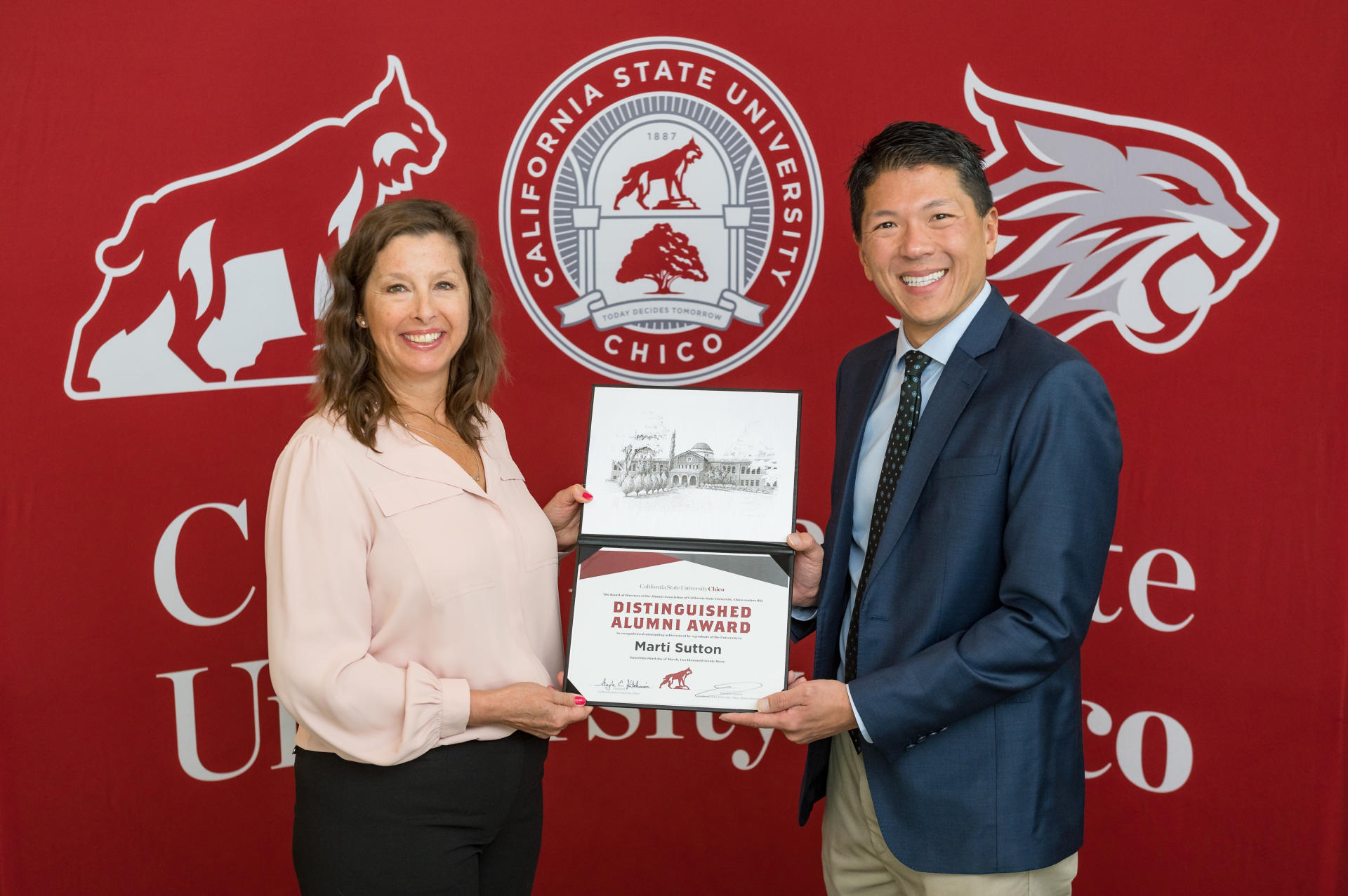 Marti Sutton receives the 2023 Distinguished Alumna award from Dean Terence Lau