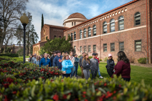 A group of people touring the Chico State campus.