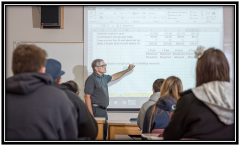 Faculty teaching a course to students.