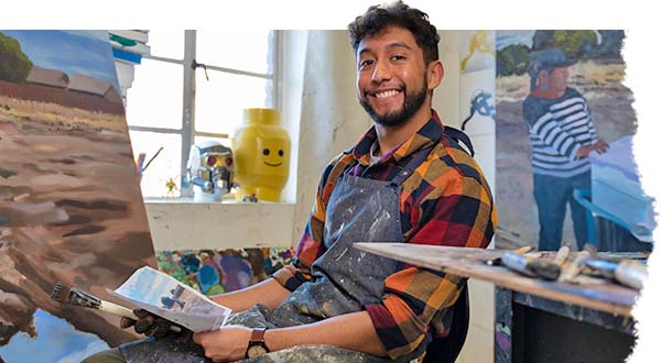 Joel Solis sits in the painting studio on campus