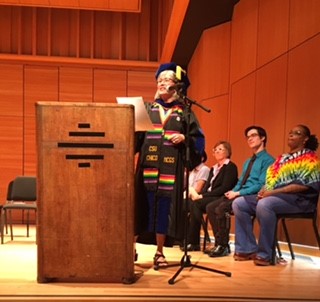 Faculty member giving a speech at the graduation ceremony