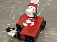 Small, red remote vehicle with sensors attached