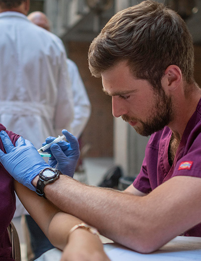 student nurse administering flu shot