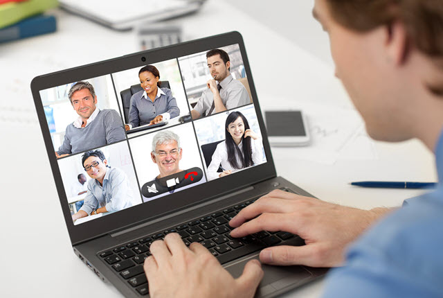Person on laptop showing virtual meeting session on screen
