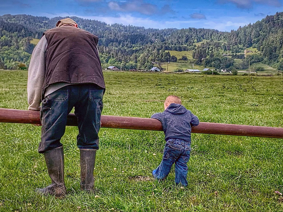 child and grandfather discuss life on the farm