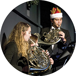 2 students playing the french horn