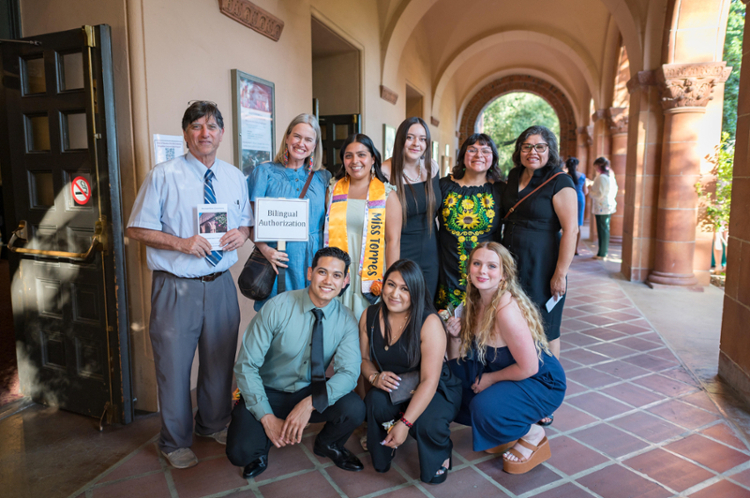 three professors and six students group together outside of Laxson Auditorium prior to the Spring 2023 Credential Ceremony