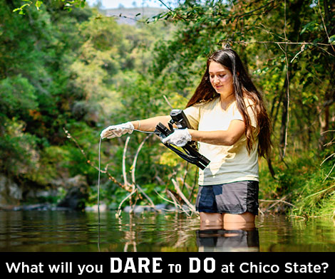 An invitation to do and dare at Chico State show a lush creek with a student.