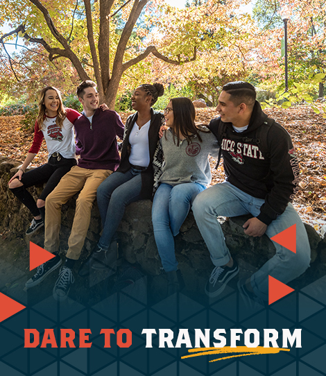 Several students sit together with fall leaves with text, dare to transform
