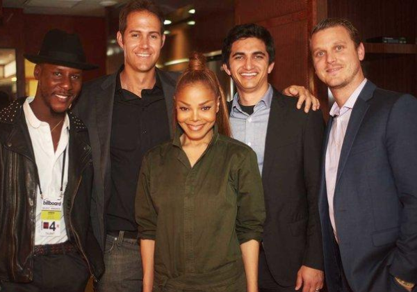 Barry Daffurn standing with Janet Jackson and three musicians.