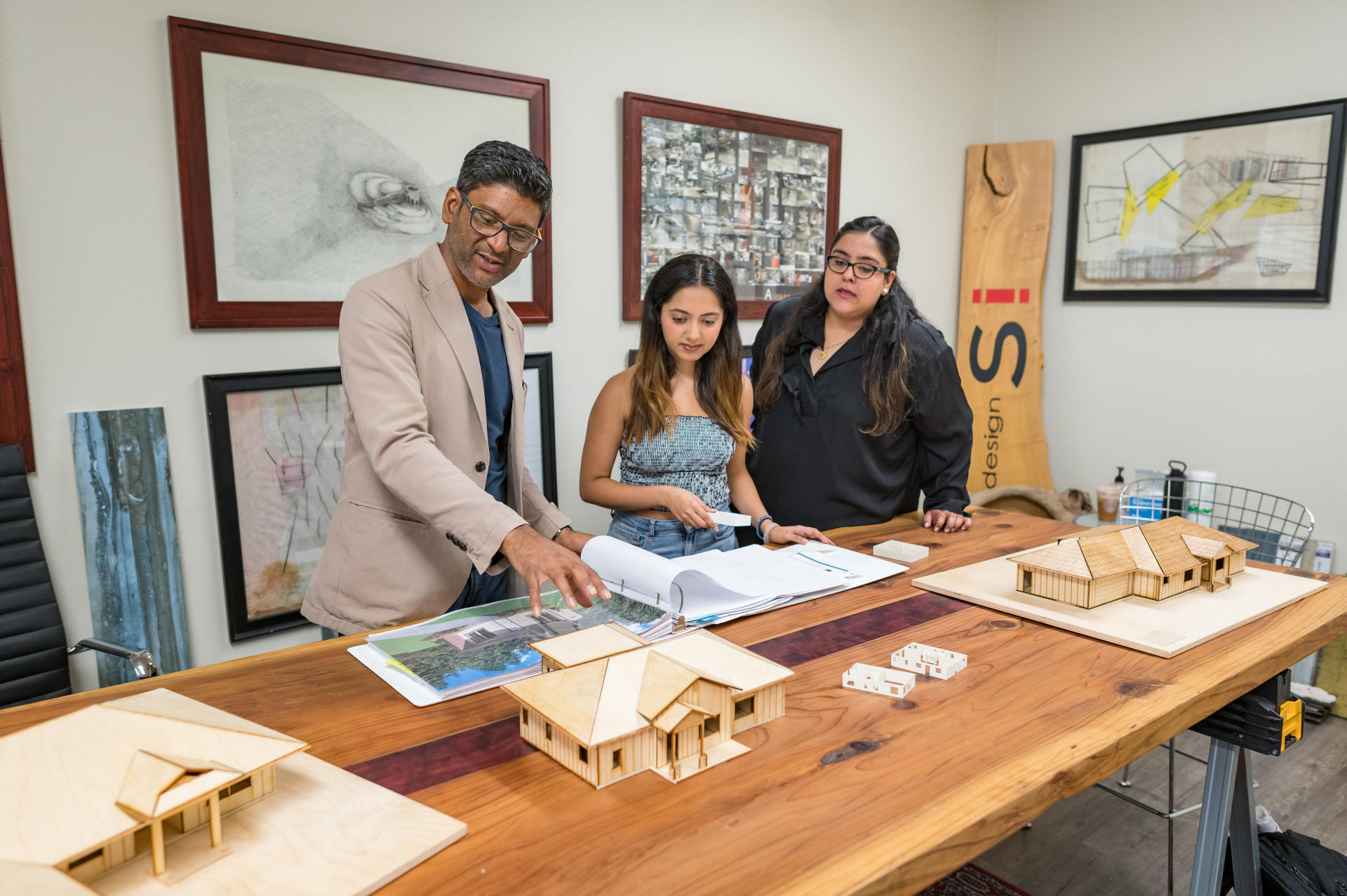 Professor Rouben Mohiuddin works with students on home designs.