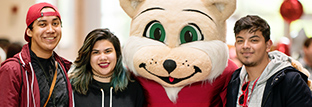 Smiling people attend Choose Chico! day and pose for pictures with Willie the Wildcat