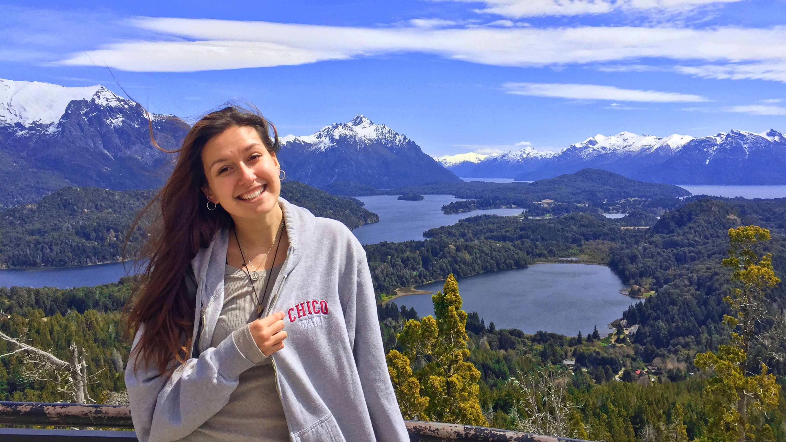 student holding chico state pennant abroad
