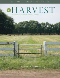 Magazine cover featuring farm fence with field and trees in background