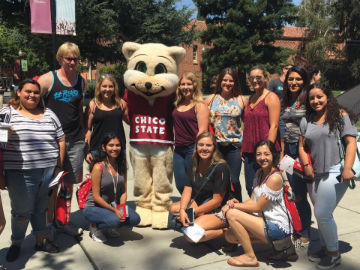 students pose with Willie the Wildcat