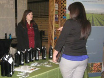 Student checks out a display from Farm Credit West at the career fair