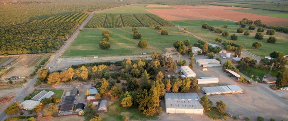 Aerial view of the university farm buildings, orchards, and pastures