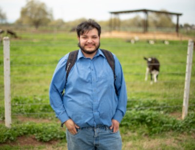 Student standing in field. 