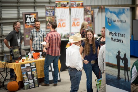 Students and employers visit at a tradeshow