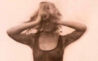 Student photograph of girl with hands over head