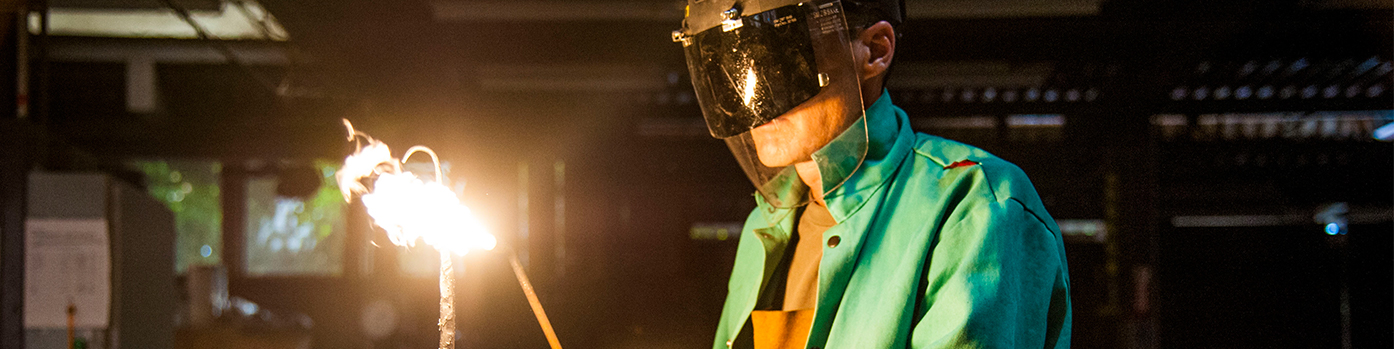 man in welding masking using a torch