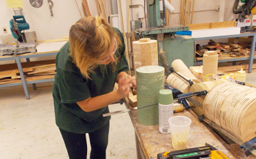 A girl working inside the woodshop