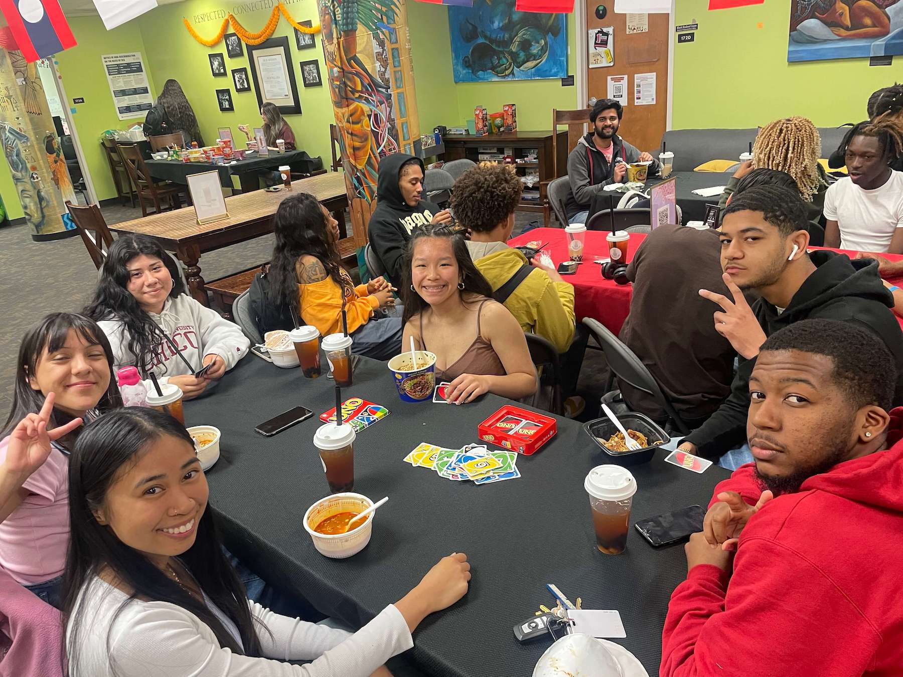 A group of diverse students enjoying conversation over ramen