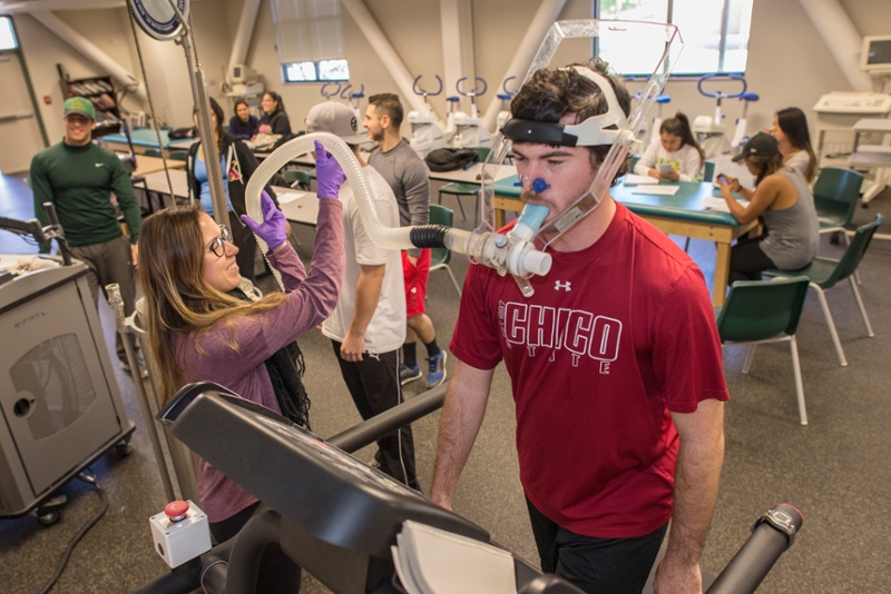 Student on treadmill with oxygen mask during a Kinesiology class.