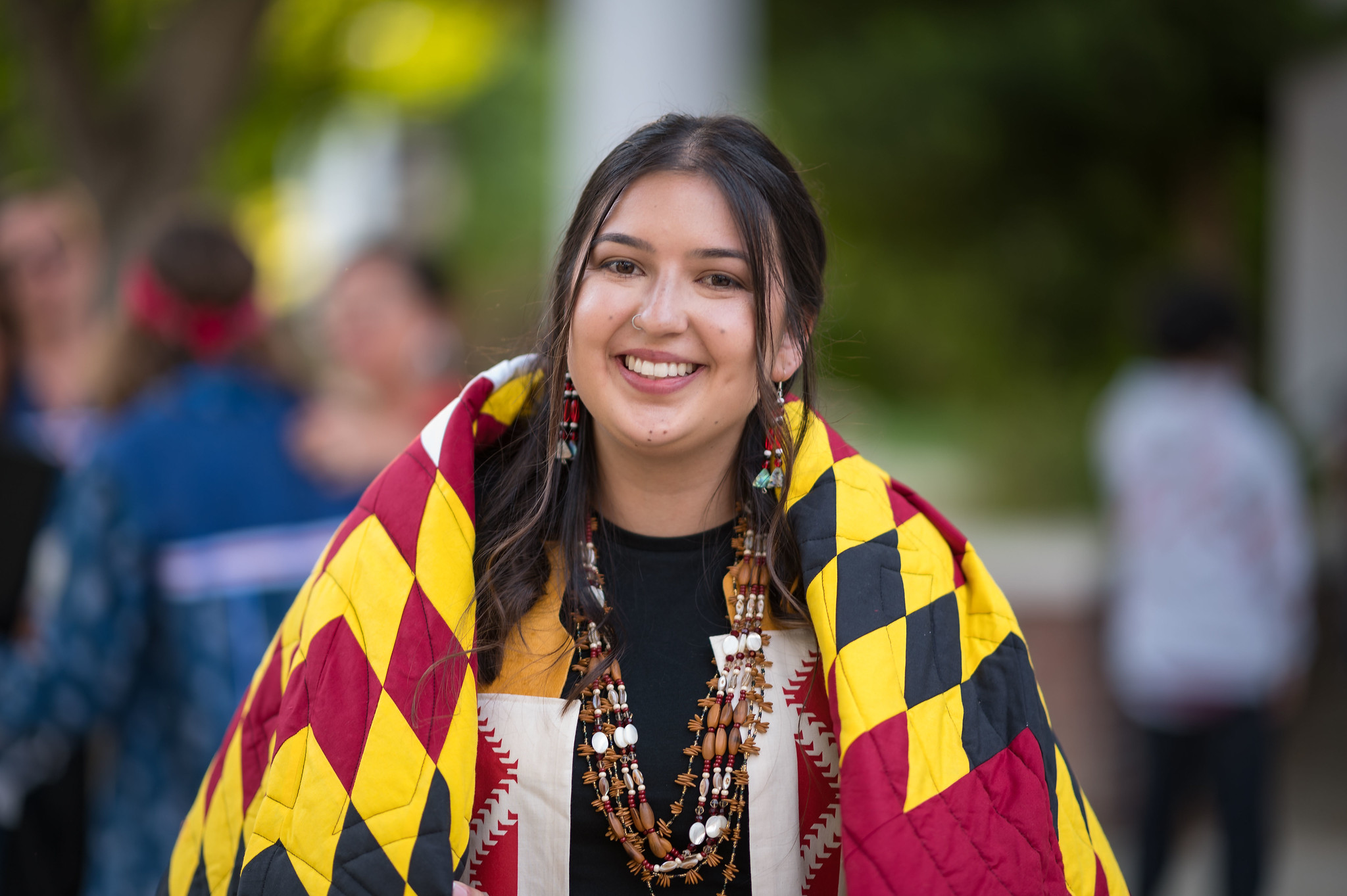 New graduate wears both academic and tribal regalia