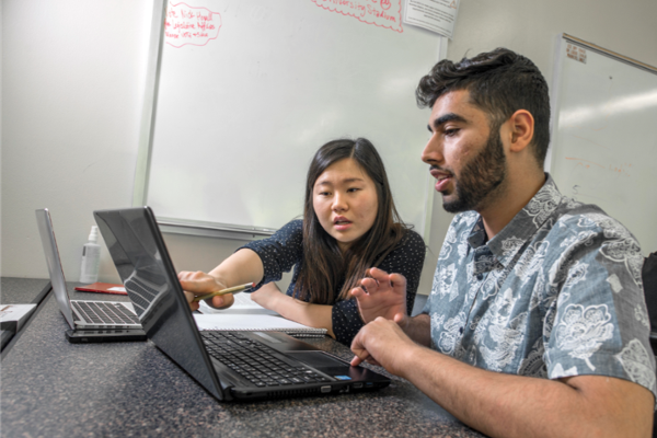 Kyungmin Yeo (left) tutors student Mohammed Khan (right) in the Business Student Success Center. Click to read more.