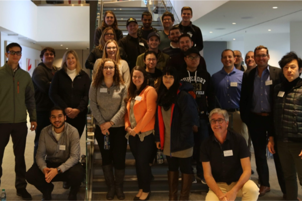 MBA students take a group photo in the Verizon Innovation Lab facility.