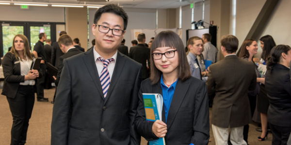 YuXiang Shi (left), Liuzhuo Tan (right) and other business students partake in the professional development event, Meet the Firms