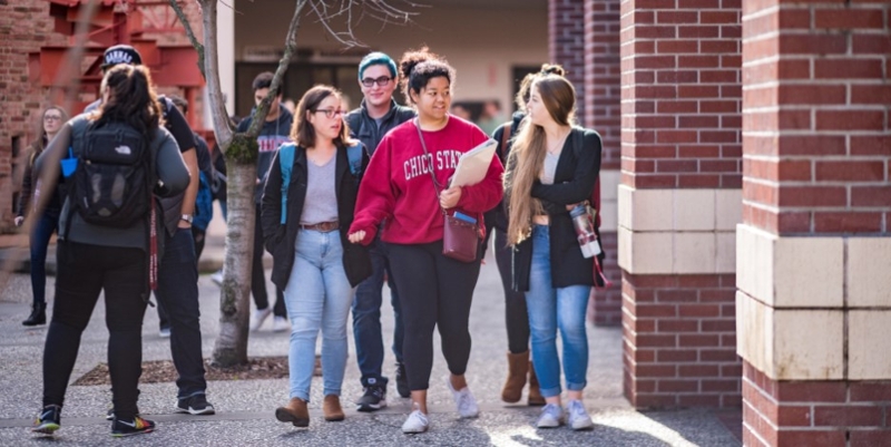 Students walking outside their dorms on Chico State campus.