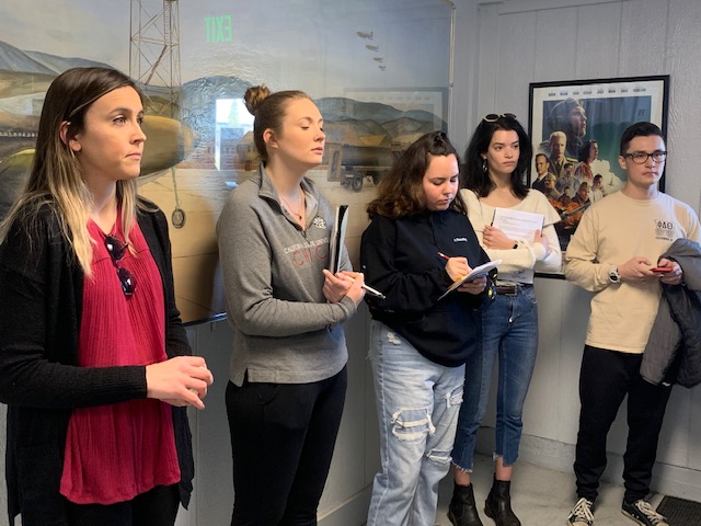 From left to right: Tayler Mackey, Mary Pekarek, Jessica Rodriguez, Cleo Hadid, and Tennyson Show listen to Brian Baldridge (not pictured), Chico Air Museum president, speak.  