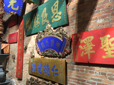 chinese writing on flags hung on brick wall