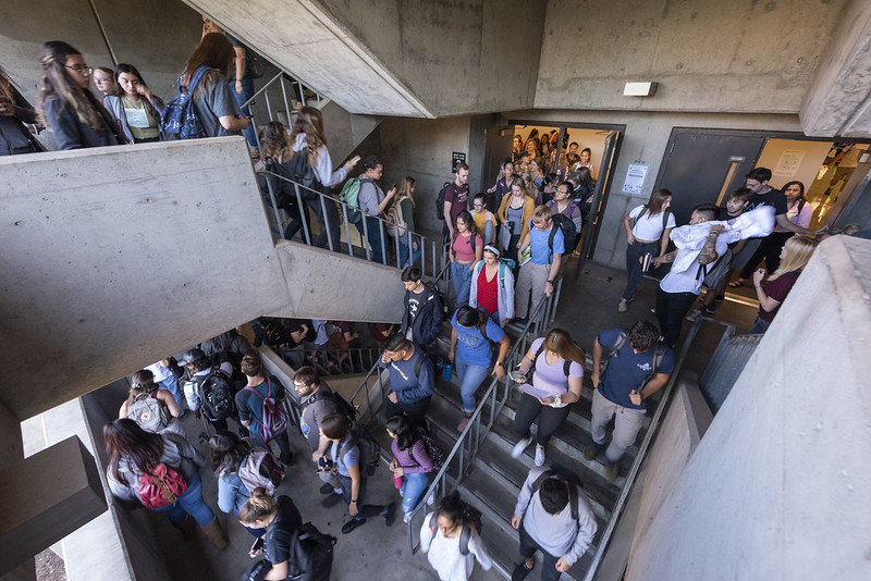 students walking up and down stairwell of building