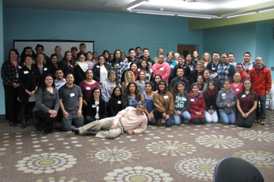 A group of first generation students, faculty, and staff pose after an event