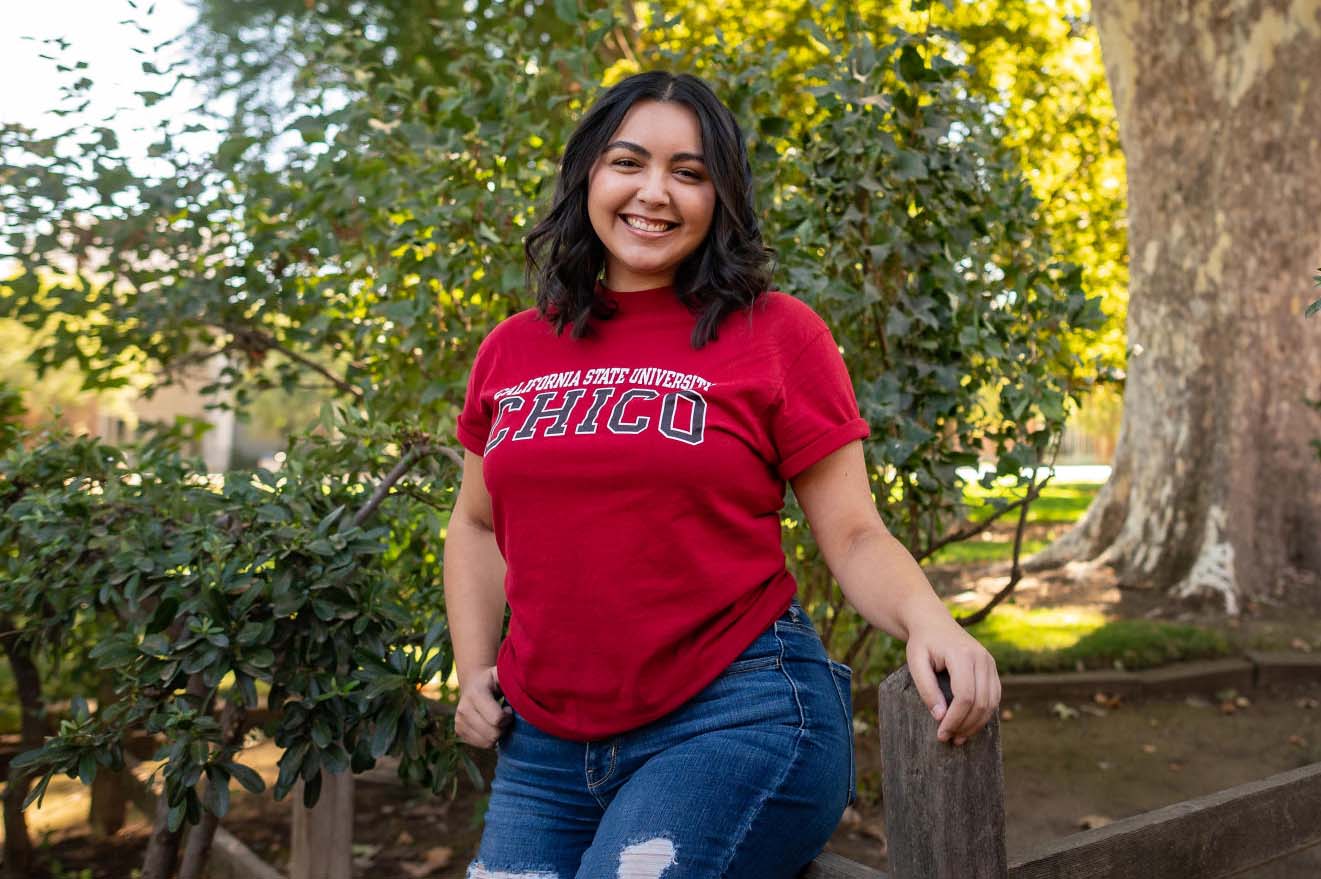 A Latina student poses on campus
