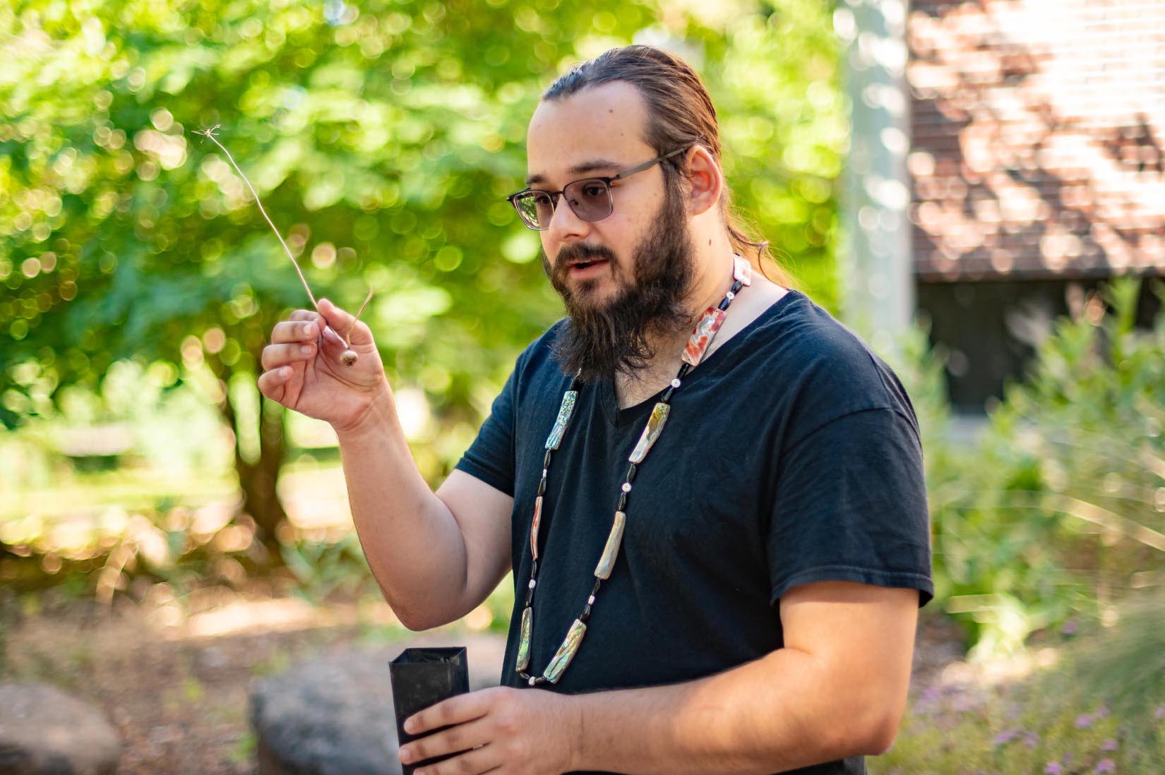 A Native American student gives a native plant tour on campus