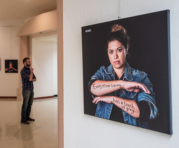 Several portraits are on display for the Dear World Photo Exhibit in the Kendall Hall Rotunda