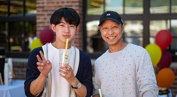 Two students smile at the international student welcome