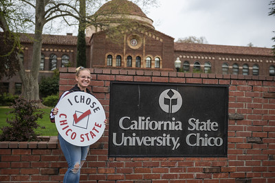 Student holding I Chose Chico sign