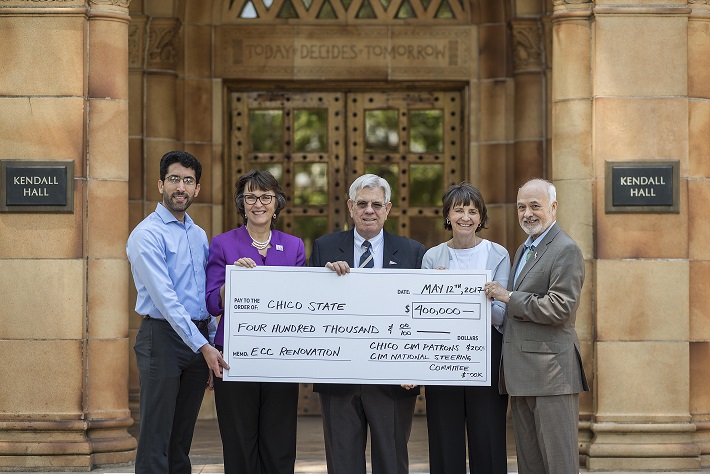 CIM Patrons present university leadership with a donation check in May 2017 in front of Kendall Hall