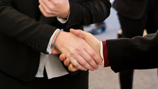 two people shake hands