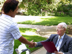 John Smale shaking hands with a student